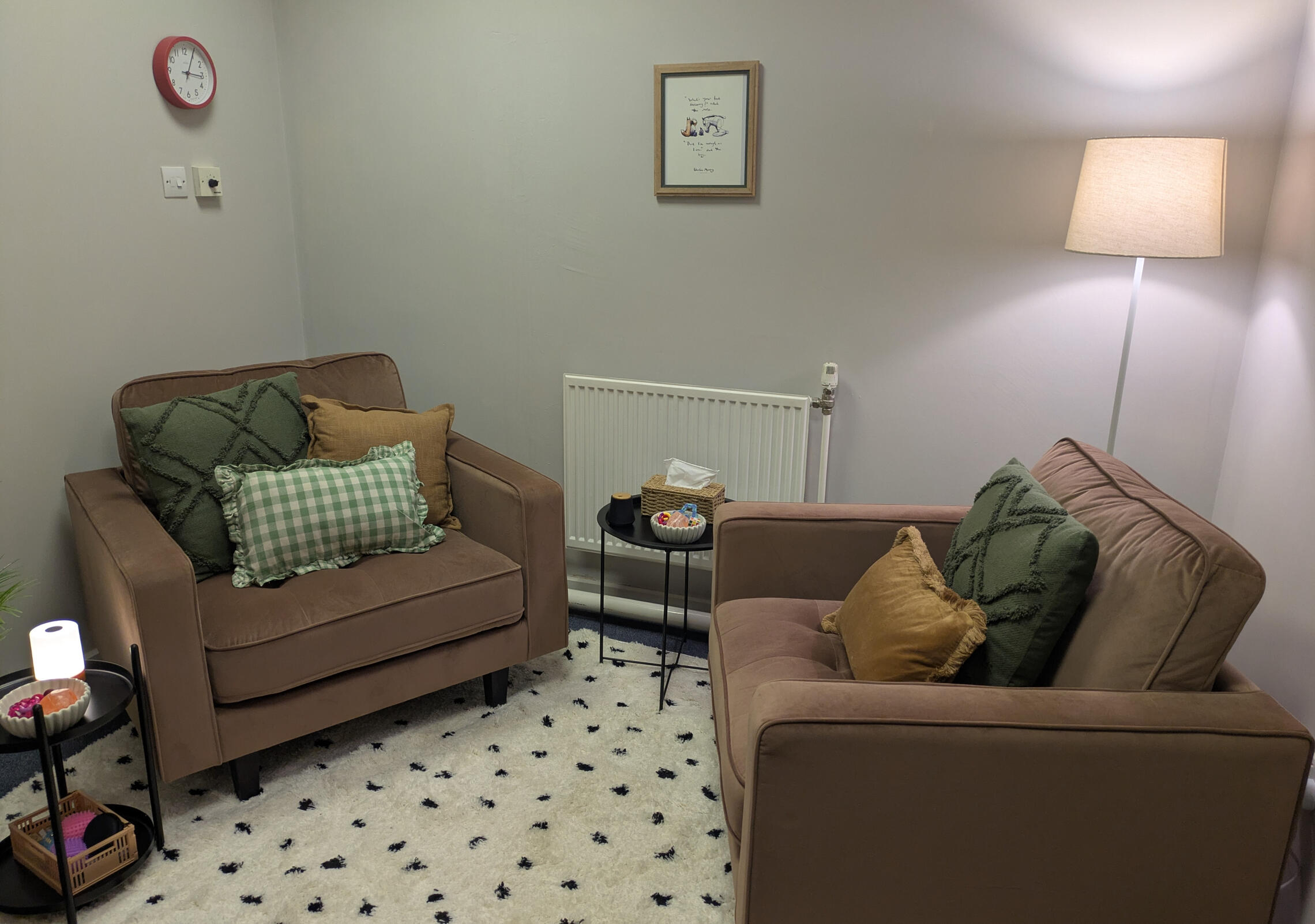 Counselling Room based in Burslem ST6. Image shows two large chairs sat opposite each other with lots of plants and dimmed lighting and candles. Counselling office based in Burslem ST6.
